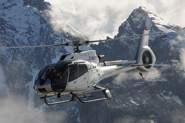 Helicopter flying through mountains
